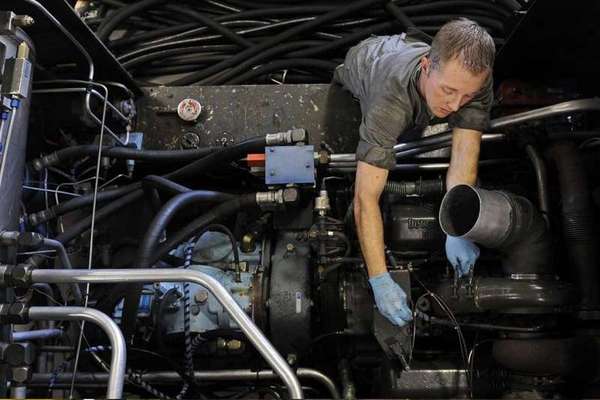 Technician performing maintenance on a generator